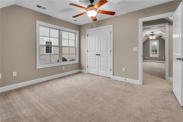 114 Royal Troon, Campobello, SC 29322 - unfurnished bedroom featuring visible vents, baseboards, a closet, lofted ceiling, and light colored carpet