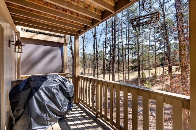 wooden deck featuring a grill