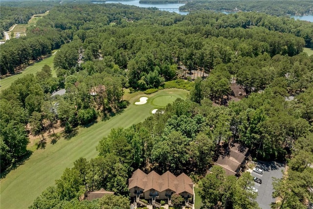 drone / aerial view featuring a forest view and a water view