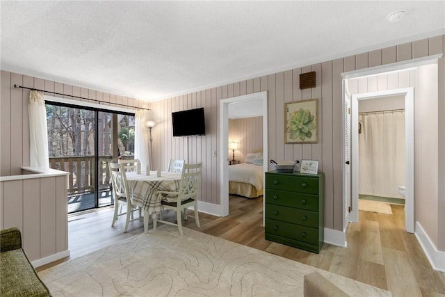 dining space with wood finished floors and baseboards