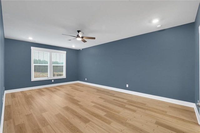 empty room with baseboards, light wood-style floors, and a ceiling fan