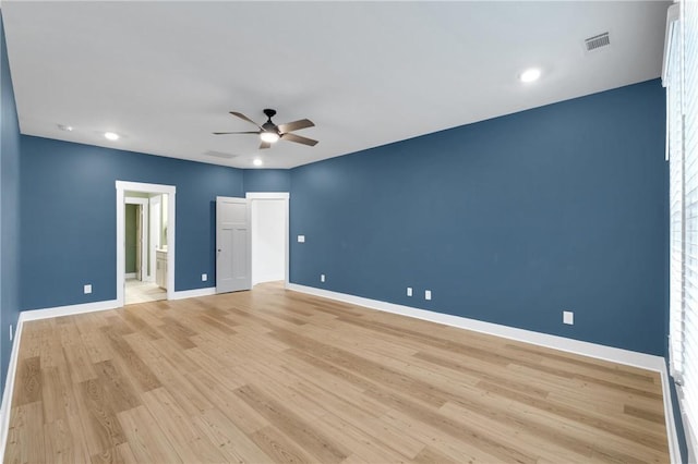 empty room featuring ceiling fan, visible vents, baseboards, and light wood-style flooring