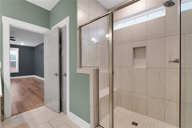 bathroom featuring baseboards and a stall shower