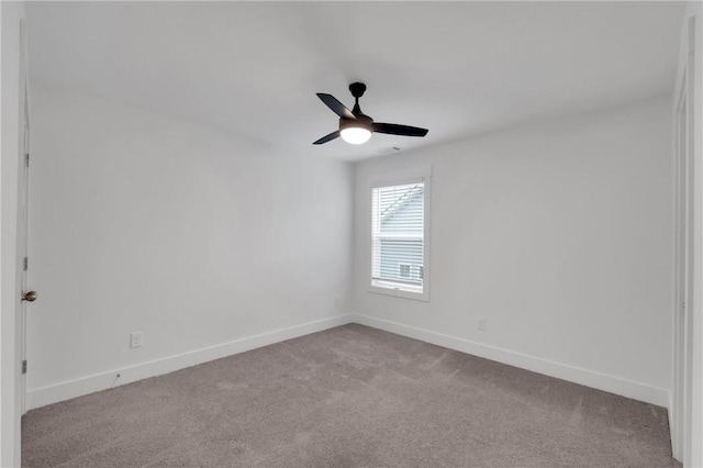 empty room with baseboards, carpet floors, and ceiling fan