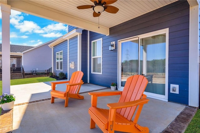 view of patio / terrace with ceiling fan and fence