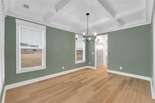 unfurnished room with visible vents, baseboards, coffered ceiling, and light wood-style flooring