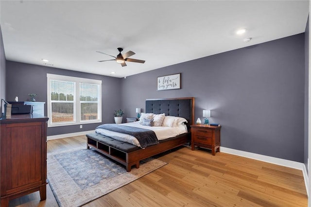 bedroom featuring baseboards, ceiling fan, and light wood finished floors