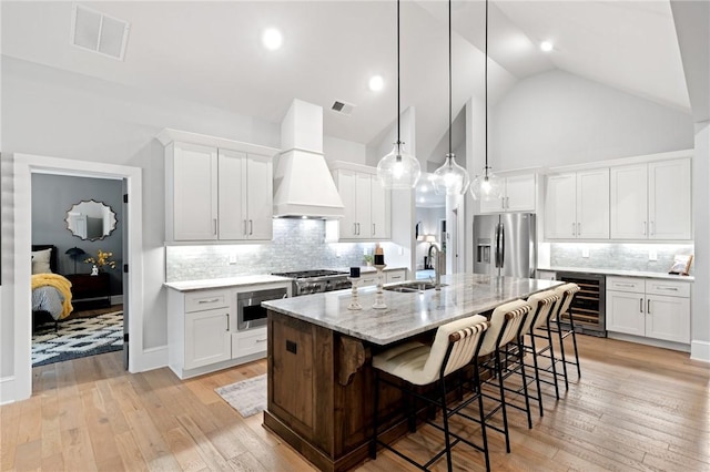 505 Bellhaven Ct, Salem, SC 29676 - kitchen featuring visible vents, a sink, custom range hood, wine cooler, and stainless steel fridge