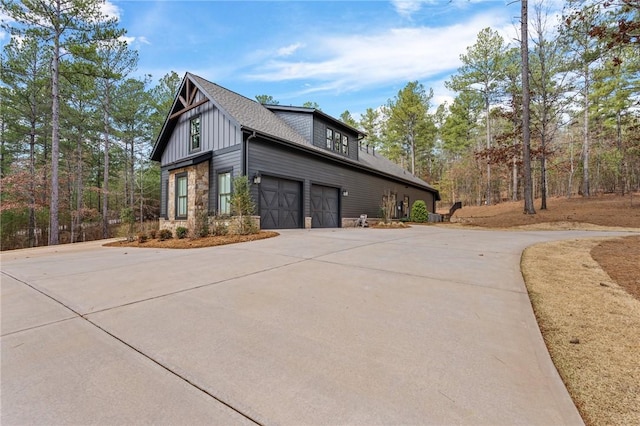 505 Bellhaven Ct, Salem, SC 29676 - view of side of home featuring stone siding, board and batten siding, driveway, and a shingled roof