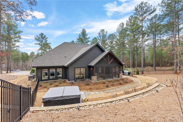 505 Bellhaven Ct, Salem, SC 29676 - rear view of house featuring roof with shingles, fence, a sunroom, and a hot tub