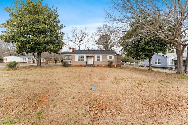 ranch-style house featuring crawl space, a chimney, a front lawn, and fence