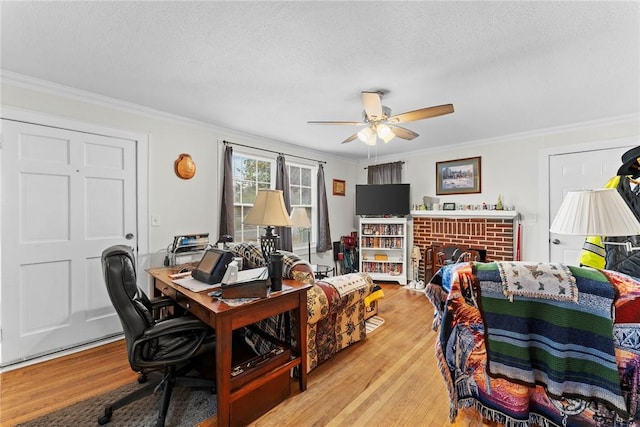 office area with crown molding, wood finished floors, and a textured ceiling