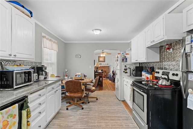 kitchen with appliances with stainless steel finishes, white cabinetry, and a ceiling fan