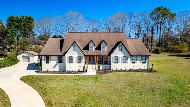 view of front facade featuring an outbuilding, a garage, concrete driveway, a front yard, and crawl space