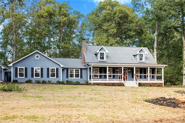 cape cod home with a front lawn, covered porch, and a chimney