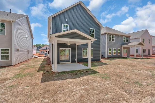 back of house featuring a ceiling fan, a patio area, and a yard