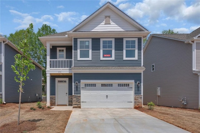 craftsman inspired home featuring a garage, a balcony, stone siding, and concrete driveway