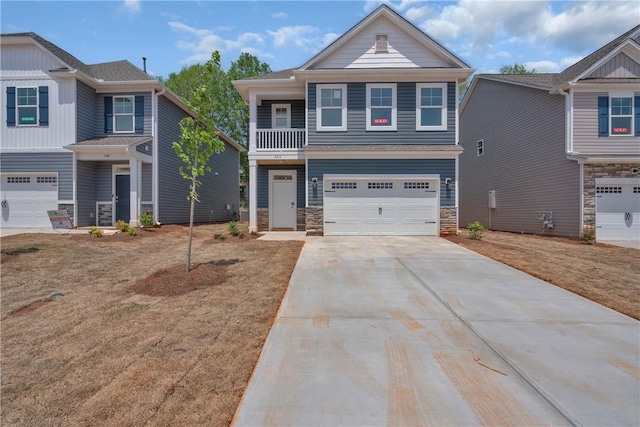 view of front of property with an attached garage, driveway, and stone siding
