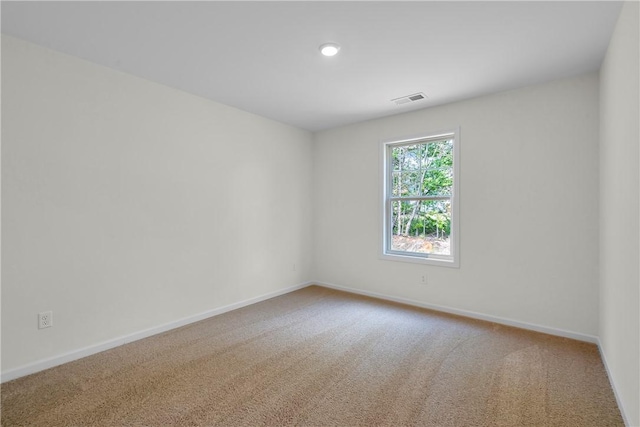 empty room featuring recessed lighting, baseboards, visible vents, and carpet