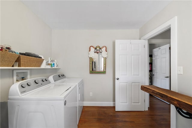 washroom with baseboards, separate washer and dryer, wood finished floors, and laundry area