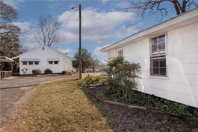 view of side of property with a lawn