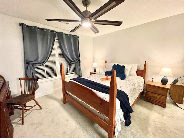 carpeted bedroom with baseboards and a ceiling fan