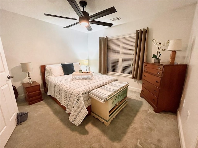 bedroom with light carpet, visible vents, ceiling fan, and baseboards