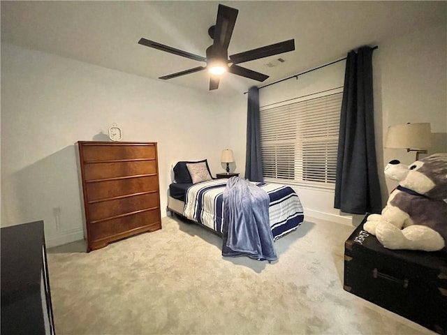 bedroom featuring a ceiling fan, baseboards, and carpet floors