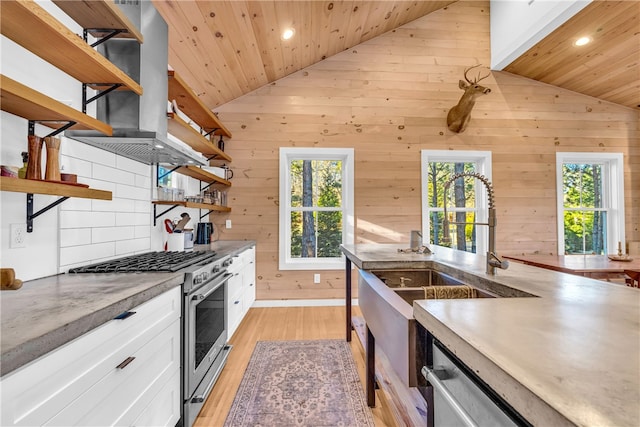 kitchen featuring open shelves, white cabinetry, stainless steel appliances, light wood finished floors, and lofted ceiling