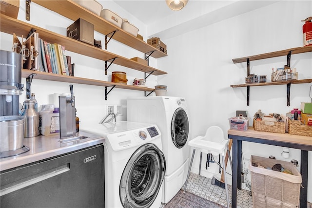 clothes washing area with tile patterned flooring, laundry area, and washer and dryer