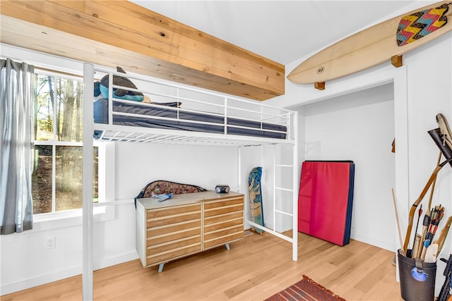 bedroom featuring wood finished floors and baseboards