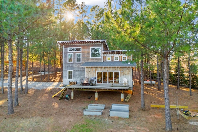 rear view of property featuring a wooden deck