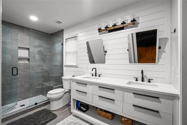 bathroom with a sink, visible vents, toilet, and a shower stall