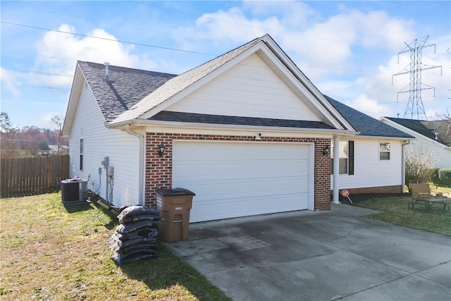 view of side of property featuring brick siding, fence, cooling unit, a garage, and driveway