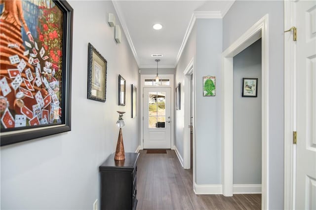 corridor featuring recessed lighting, baseboards, dark wood finished floors, and crown molding