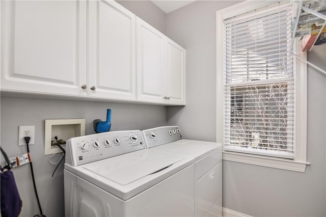 washroom with cabinet space and independent washer and dryer