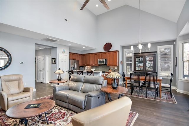 living room featuring dark wood-type flooring, recessed lighting, baseboards, and a chandelier