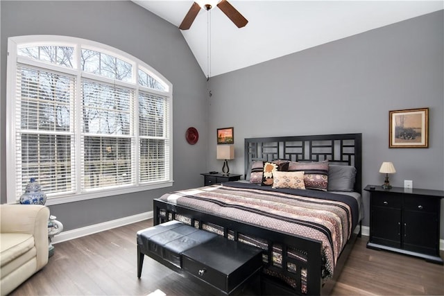 bedroom with multiple windows, lofted ceiling, and wood finished floors