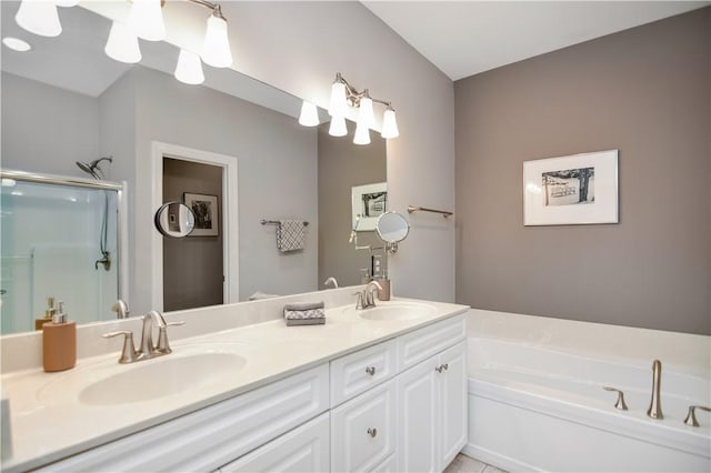 bathroom featuring double vanity, a bath, a stall shower, and a sink