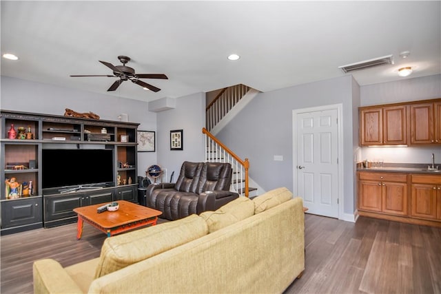 living area with visible vents, dark wood finished floors, recessed lighting, ceiling fan, and stairs