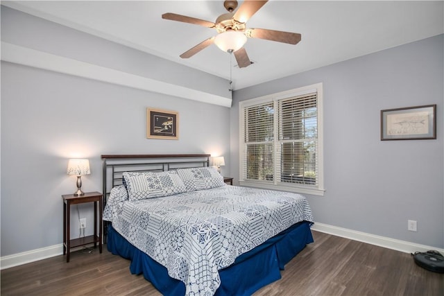 bedroom featuring baseboards, wood finished floors, and a ceiling fan