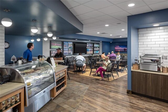 interior space with wood finished floors, recessed lighting, and a paneled ceiling