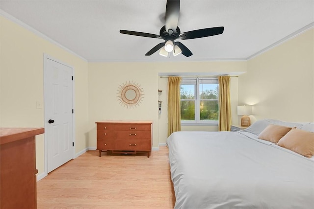 bedroom with ceiling fan, baseboards, light wood-style flooring, and crown molding