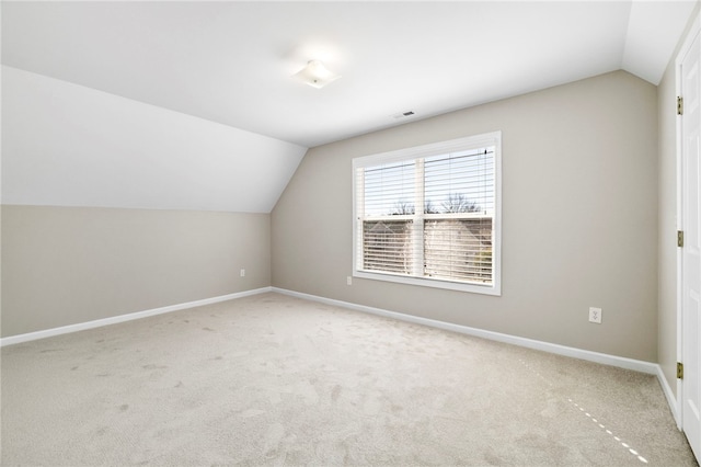 bonus room with vaulted ceiling, carpet flooring, visible vents, and baseboards