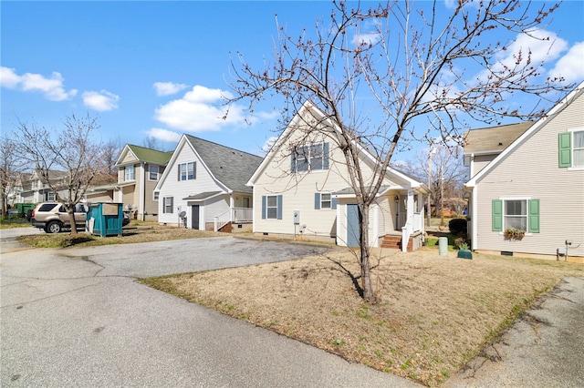 view of front of house featuring aphalt driveway and a residential view