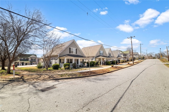 view of street with sidewalks, curbs, and a residential view