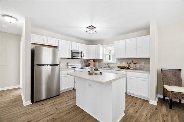 kitchen with white cabinetry, light countertops, appliances with stainless steel finishes, and a sink