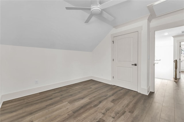 additional living space featuring ceiling fan, baseboards, wood finished floors, and vaulted ceiling