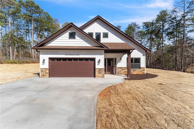 modern farmhouse style home with concrete driveway, a garage, stone siding, and a shingled roof