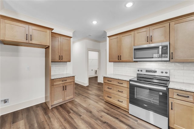 kitchen featuring light stone counters, tasteful backsplash, dark wood finished floors, appliances with stainless steel finishes, and baseboards